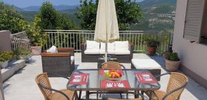 a table with a bowl of fruit on a patio at George Poros house in Poros