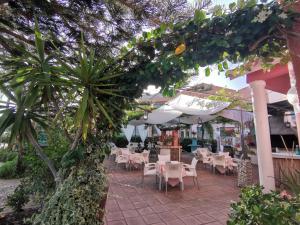 a patio area with tables, chairs and umbrellas at El Tio Mateo in Marbella