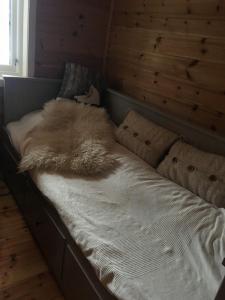a bed with a furry blanket on top of it at Rauland in Rauland