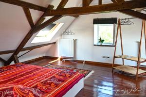 a attic bedroom with a bed and a window at Landhaus Lontzen in Lontzen