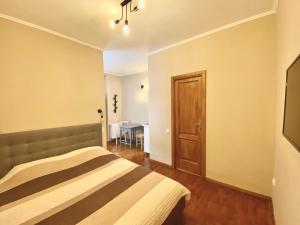 a bedroom with a bed and a dining room at APARTAMENT JOHANN GOTT in Braşov