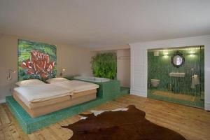 a bedroom with a bed with a painting on the wall at Hotel Löwen in Lahr