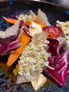 a plate of food with vegetables and cheese on it at Bobergs på Hamngården in Brantevik