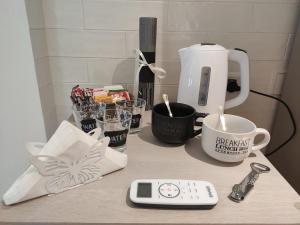a counter top with a coffee maker and a remote control at Fiumicino Dream & Fly 2 in Fiumicino
