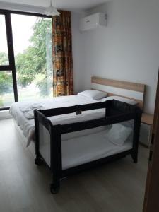a bedroom with a bed and a large window at Лукс апартамент Алекс in Blagoevgrad