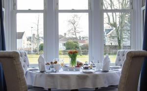 una mesa con un mantel blanco y comida en ella en Mount Barker, en Grantown-on-Spey