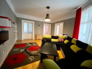 a living room with a couch and a table at Casa Balcescu in Braşov