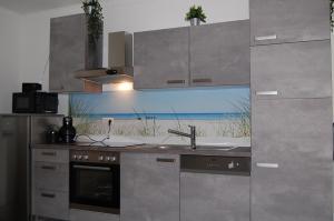 a kitchen with a view of the beach at Weingut Krikler in Weiden am See