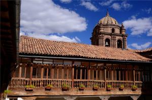 a building with potted plants and a clock tower at Unaytambo Boutique Hotel Cusco in Cusco +24 photos