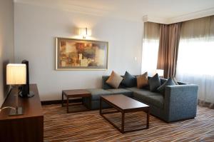 a living room filled with furniture and a couch at Holiday Inn Abu Dhabi Downtown, an IHG Hotel in Abu Dhabi