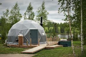 a large dome tent on a deck in a field at Glamping DiDille in Drusti