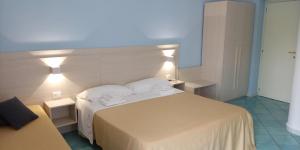 a bedroom with a white bed with two towels on it at Borgo 800 in San Nicola Arcella