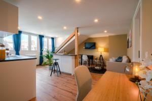 a living room with a kitchen and a dining room at Kaiser9 in Saarbrücken