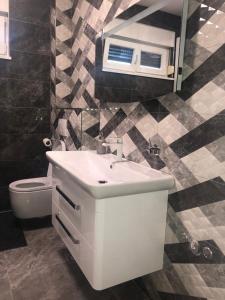 a bathroom with a sink and a mirror and a toilet at LUXURY VILLA HELENA in Kaštela +35 photos
