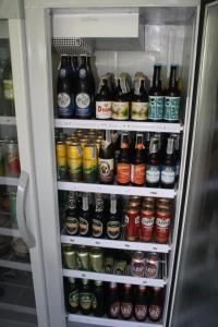 a refrigerator filled with lots of bottles of beer at Kuba Bungalows in Ko Kood