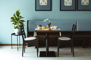 a table with chairs and a table with fruit on it at Albergo Commercio in Palmanova