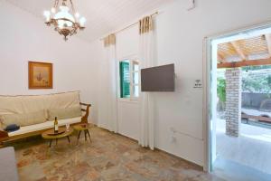 a living room with a couch and a tv at Minimalist Cozy House in Corfu