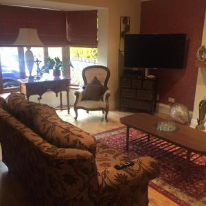a living room with a couch and a table at Beechtree House in Dublin +2 photos