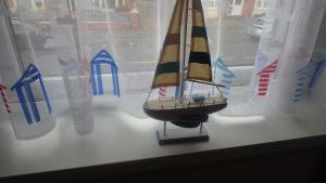 a small toy boat sitting on a window sill at The Victoria guest house in Mablethorpe