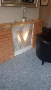 a brick fireplace with a light on it at The Victoria guest house in Mablethorpe