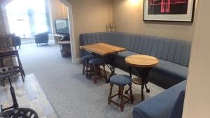 a bar with a table and stools in a room at The Victoria guest house in Mablethorpe