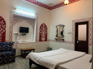 Postel nebo postele na pokoji v ubytování Vinayak Guest House