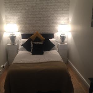 a bedroom with a bed with two lamps on it at Beechtree House in Dublin