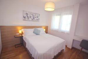 Postel nebo postele na pokoji v ubytování Sun Apartments