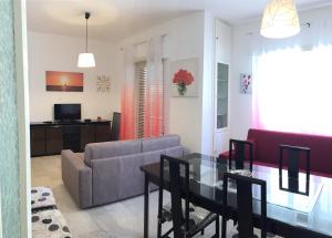 a living room with a couch and a table at Central Holiday Home Sperlonga in Sperlonga