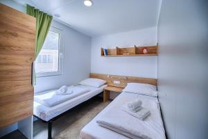 A bed or beds in a room at Boutique Camping Bunja