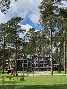 an apartment building with trees in front of it at Apartament Meralia in Augustów