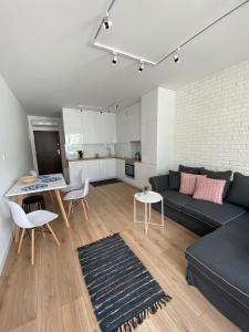 a living room with a couch and a table at Apartament Meralia in Augustów