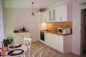 a small kitchen with a table and a microwave at Andreya's Sea apartment-Beach, Sea garden ,Old Town, Free Parking, Free EVcharging Station in Varna City