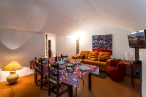 a living room with a table and a couch at Villa Glicine in Gardone Riviera