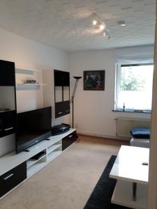 a living room with a large flat screen tv at Ferienwohnung Pries in Kiel