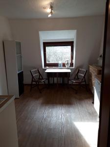 a kitchen with a table and chairs and a window at Ferienwohnung Pries in Kiel