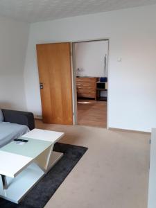 a living room with a couch and a table at Ferienwohnung Pries in Kiel