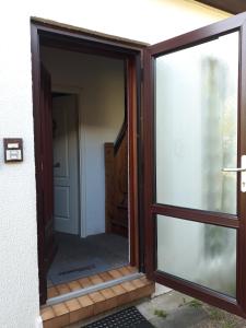 a sliding glass door leading into a room with a door at Ferienwohnung Pries in Kiel