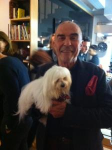 a man is holding a small white dog at Maison Mouillard in Lyon