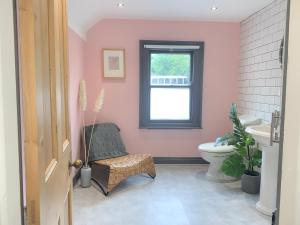 a bathroom with a toilet and a window at Causeway Coast Townhouse in Ballycastle