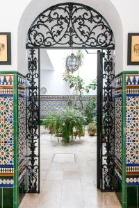 an ornate gate in the courtyard of a building at Conde Collection Gran Poder in Seville