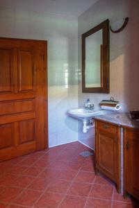 a bathroom with a sink and a mirror at House Donačka Gora in Rogatec