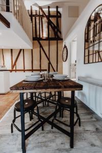 a dining room with a wooden table and chairs at L'échappée in Bourges