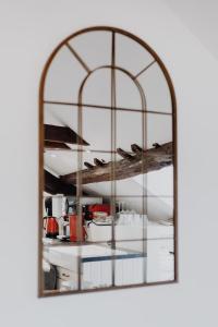 a mirror reflection of a kitchen in a room at L'échappée in Bourges