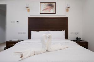 Postel nebo postele na pokoji v ubytování Alhattali Hotel