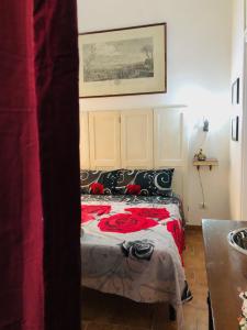 a bedroom with a bed with a red blanket at A Casa di Claudia in Naples