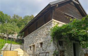 an old stone house with a wooden roof at Amazing Home In Tolmin With Sauna in Tolmin