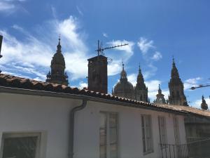 a building with a clock on top of it at Albergue Azabache in Santiago de Compostela