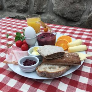 a plate of breakfast food on a picnic table at Hillesgården in Boarp