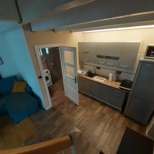 a kitchen with a blue couch in a room at Letnia Ostoja Wieprz in Wieprz +15 photos